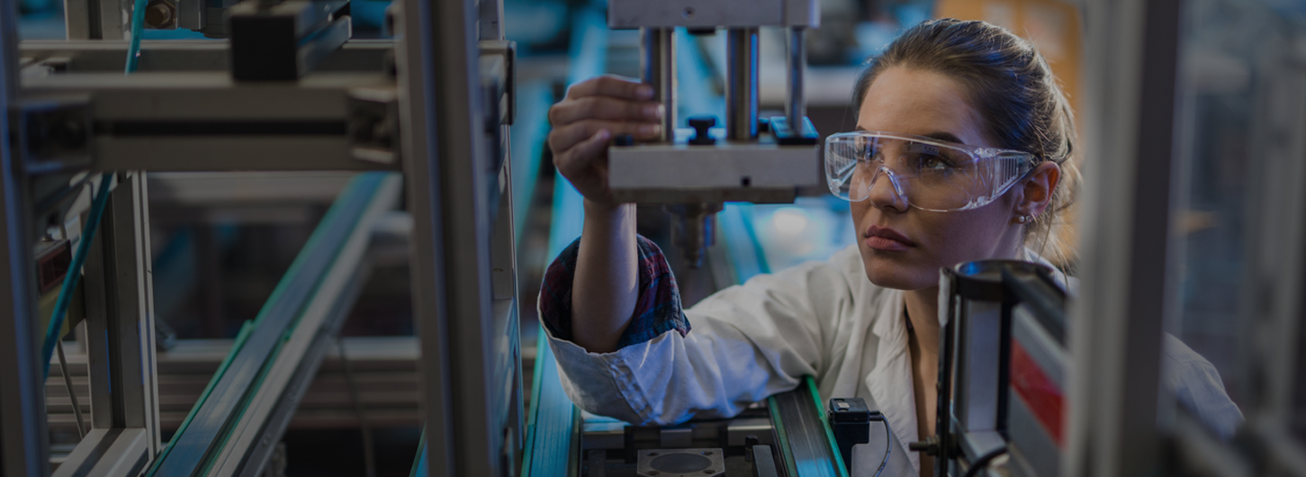 Quality control worker analyzing machine part in laboratory